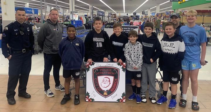 [CREDIT: WPD] Sgt. Steve Moretti, Officers Michael Rosa & Patrick Holmes, members of the PAL Warwick Warriors Basketball 4th & 8th Grade Boys teams (w/ Brayden – JV Pats Football), and the Warwick Police Explorers pitched in at Walmart during the WPD Toy Drive.