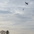 [CREDIT: RI Breaking News Service] The RI National Guard used helicopters to help crews fight an Exeter brush fire Friday.