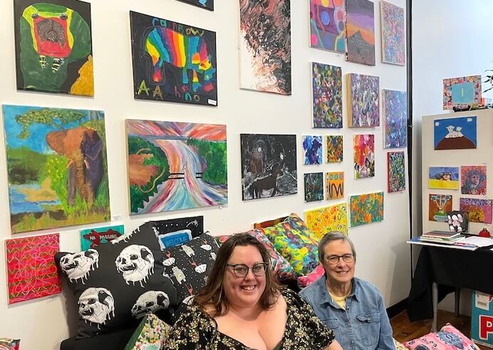 [CREDIT: Rob Borkowski] Carrie Hyde, Outsider Collective director, and Anne Landis, a member of the board, inside the gallery and work space at Hope Artiste Village in Pawtucket. 