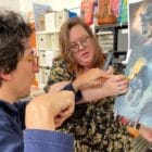 [CREDIT: Rob Borkowski] Federico “Freddy” Rocco works on a painting from a print of a panther with the help of Carrie Hyde, Outsider Collective director.