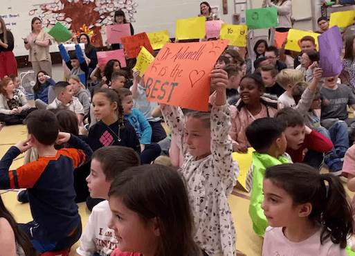 [CREDIT: Mayor Picozzi's Office] Norwood Principal Sabrina Antonelli was named RI Elementary Principal of the Year this week. Students cheered the news in the school's auditorium.