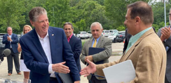 [CREDIT: Gov. McKee's Office] From left, Gov. Dan McKee and House Speaker Joe Shekarchi shake hands during the kickoff of a $25M project to finish Rte. 37 upgrades. Center, from left, Mayor Frank Picozzi and Sen. Jack Reed, who helped create the RAISE grant program in 2009 and helped include $7.5 billion for it in the Bipartisan Infrastructure Law.