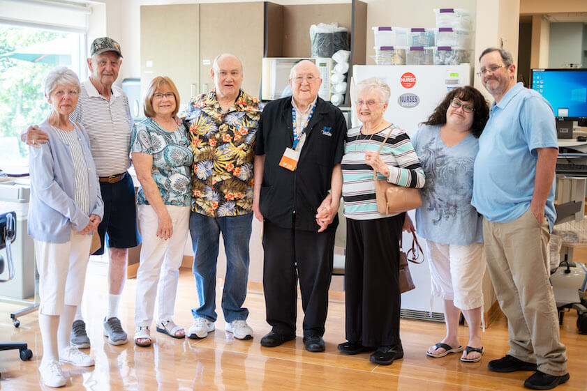 [CREDIT: Kent Hospital] At left, John and Elaine Murray, who surprised Al Stanford, volunteer at Kent Hospital, center, with the help of his wife, family and hosptial staff July 14, 2023.