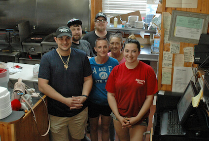 [CREDIT: Rob Borkowski] Pictured, in front, from left, Santoro's Pizza's owners Nicholas and Deanna Labrakis. Between them, from left, are kitchen crew member Michael Cirello, Noah Leonard, Caryn Page, and Pamela.