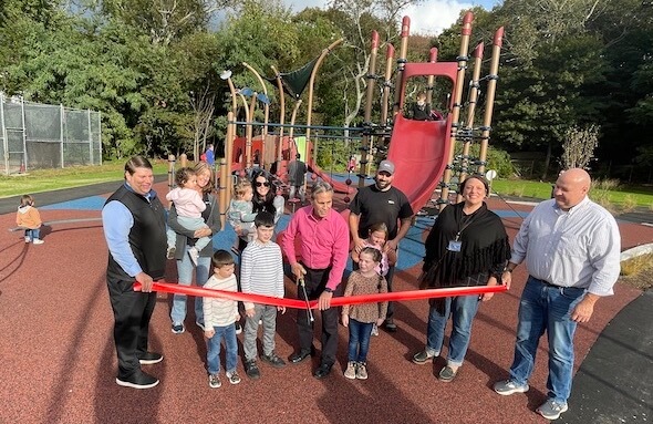 [CREDIT: Rob Borkowski] At left, City Council President Steve McAllister and Mayor Frank Picozzi, center, cut the ribbon on the new Apponaug Playground.