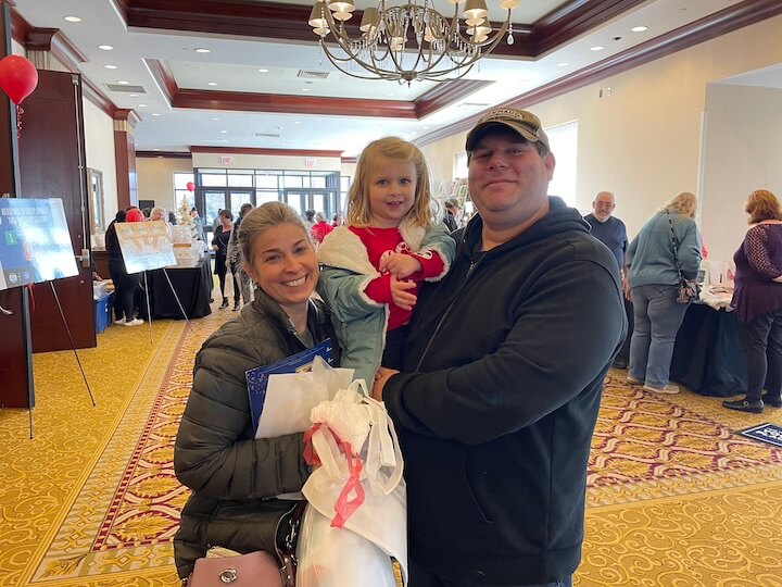 [CREDIT: Rob Borkowski] From left, Warwick City Council President Steve McAllister with his wife, Vanessa and daughter, Grace during Shop RI's Small Business Saturday at Crowne Plaza Nov. 25, 2023. "We're here every year," McAllister said.