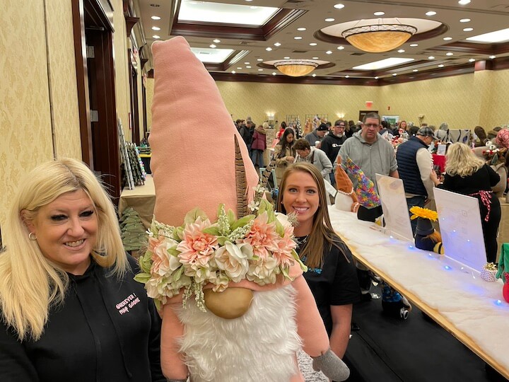 [CREDIT: Rob Borkowski] A gnome helped staff the gift shop table for Wherever I May Gnome (instagram.com/whereverimaygnome/), with, from left, owner Dawn Santos and her daughter-in-law, Kayla.