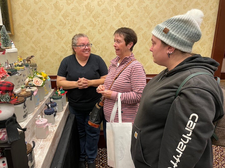 [CREDIT: Rob Borkowski] Tammy Capezza, owner of the new gift shop, Just for Fun Boutique at the Agawam Mill, 1454 Main St.,West Warwick, RI, chats with Chris and Katie Babiec during Shop RI's Small Business Saturday at Crowne Plaza Nov. 25, 2023.