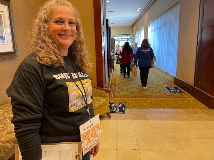 [CREDIT: Rob Borkowski] Shop RI volunteer Mary Beth Cournoyer guided shoppers trough the many halls filled with 165 small business vendors at Crowne Plaza Warwick Nov. 25.