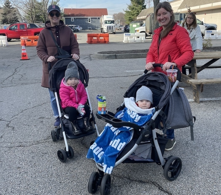 [CREDIT: Rob Borkowski] At the start of the Apponaug Winter Festival, Erin Mignosa and Everly, 2, and Jess Dickie and Bobby, 1, enjoy some quiet time near the food court. "He just turned one on Sunday," Dickie said of Bobby.