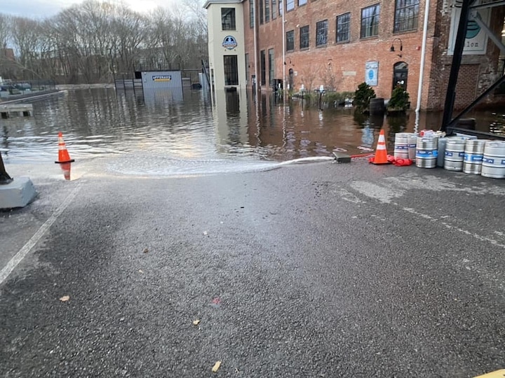 [CREDIT: Mayor Frank Picozzi] Flooding from the Dec. 18 2023 storm at the front lot of Apponaug Brewing Company in Pontiac Village, next to Pontiac Mills Apartments on Knight Street. 