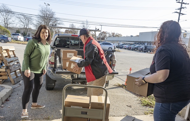 [CREDIT: RI Foundation] Amenity Aid Executive Director Liz Duggan helps load personal hygiene supplies for distribution to households in need. The Warwick nonprofit is one of three organizations whose work was just honored with Best Practice Awards by the Rhode Island Foundation and Blue Cross & Blue Shield of Rhode Island.