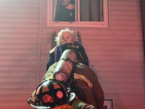 [CREDIT: Hopkins Hill Chief Frank Brown] Hopkins Hill Firefighters rescue two people trapped in their apartment by the March 11 fire at 978 Tiogue Ave. The man an woman were treated for smoke inhalation. A third resident was also treated for smoke inhalation.