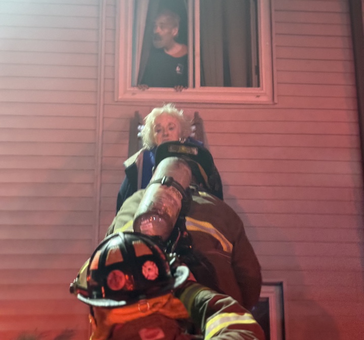 [CREDIT: Hopkins Hill Chief Frank Brown] Hopkins Hill Firefighters rescue two people trapped in their apartment by the March 11 fire at 978 Tiogue Ave. The man an woman were treated for smoke inhalation. A third resident was also treated for smoke inhalation.