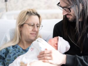 [CREDIT: Care New England] Pictured here, Warwick Leap Day Baby Sidney Lee Bilunas, shortly after arriving on-time, with parents, from left, Jessica Cullen, and Brian Bilunas.