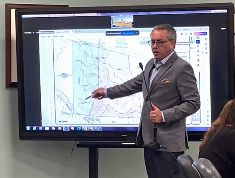 [CREDIT: Rob Borkowski] Coventry Town Solicitor and Law Department Head Stephen J. Angell points the the Soscia Holdings parcel including Johnson's Pond Dam and the access area to it, which the town will take by eminent domain for $157,000.