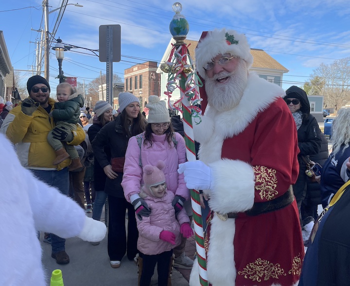 [CREDIT: Rob Borkowski] Santa and Mrs. Claus are ushered into the Central RI Chamber building for photos during the Rolling, Strolling Apponaug Winter Festival Parade Dec. 7, 2024.