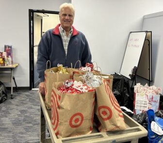 [CREDIT: Warwick City Council] Councilman Ed Ladouceur (Ward 7) with donations for local families, at West Bay Community Action. 