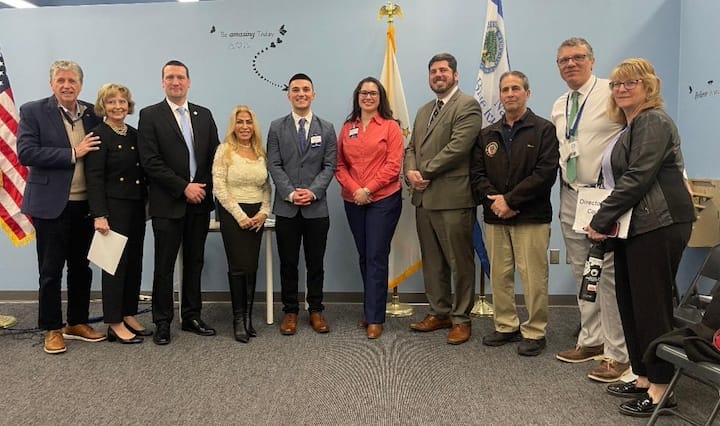 [CREDIT: Olivia DaRocha] Members of the Governor's Young Leaders Advisory Group and co-authors of the Litter-Free Rhode Island coloring book Jordan Brazeau (center left) and Margaret Price (center right) are joined by (left to right): Governor Dan McKee, First Lady Susan McKee, Warwick School Committee member Leah Hazelwood, Warwick School Committee member Shaun Galligan, Representative Joseph J. Solomon Jr. (D-Dist. 22, Warwick), Warwick Mayor Frank Picozzi (I), Park Elementary School Principal Daniel Sylvestre, and Patricia Cousineau Director of Elementary Education for Warwick Public Schools.