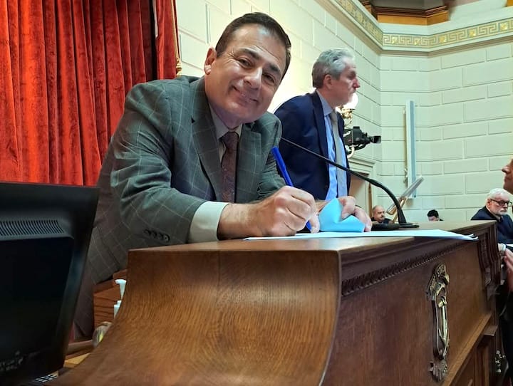 [CREDIT: Vanessa Baker] House Speaker Joe Shekarchi (D- Dist. 23, Warwick) signs the Casino smoking ban bill March 20 at the State House.