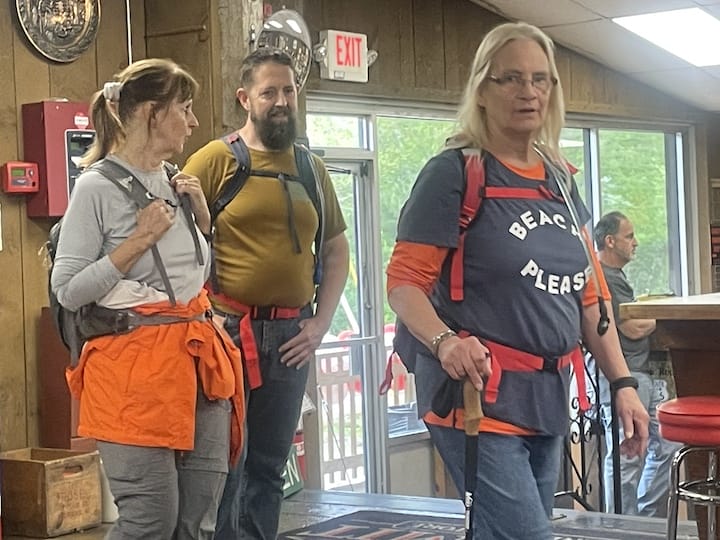 [CREDIT: Rob Borkowski] Among the customers at Suzy Q's Summit General Grand Opening, a trio of hikers, hungry after a hike on the Coventry Greenway. From left, Mark Maziarz of West Greenwich, and Karen Simpson and Ramona Roch, both of West Warwick.