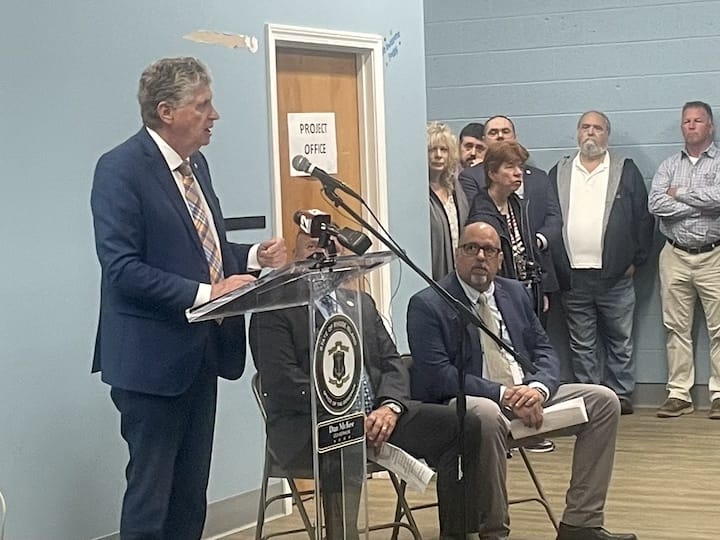 [CREDIT: Rob Borkowski] Gov. Dan McKee during the ground breaking ceremony for the Coventry Community Learning Center at the Town Hall Annex Tuesday morning. Seated, from left, are Coventry Town Manager Dan Parrillo and Coventry Human Services Director Bob Robillard.