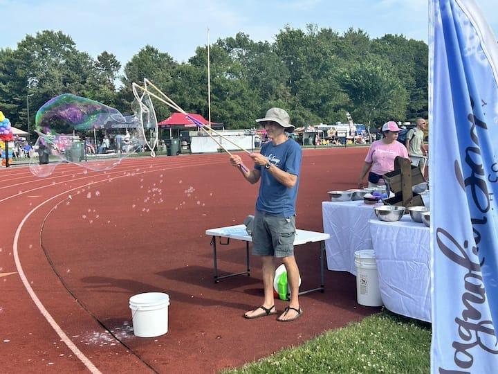 [CREDIT: Natalie Ferland] Yolie and Aaron from Magnolia Soap and Bath Co at their booth, one of the many vendors featured at the Summer Festival.
