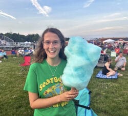 [CREDIT: Natalie Ferland] Coventry resident Kaleigh enjoys cotton candy from one of the vendors at the Summer Festival.