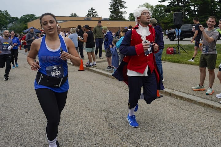[CREDIT: Laura Paton] John Ames of Providence finishes the race in his Colonial attire during the Gaspee Days 5K June 14, 2025.
