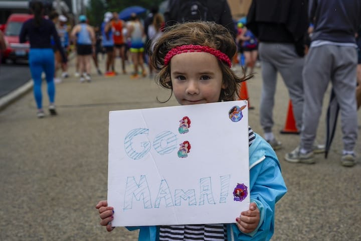 [CREDIT: Laura Paton] A child cheers on her mother who is about to cross the finish line during the Gaspee Days 5K June 14, 2025.
