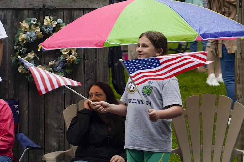[CREDIT: Laura Paton] Emma Fredericks of Burrillville shows off her patriotism as the 2025 Gaspee Days Parade passes by.