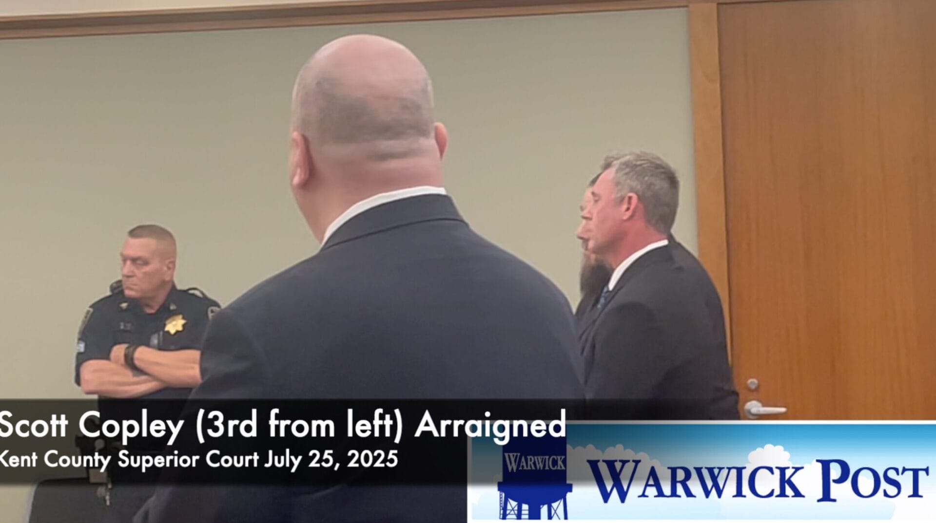 [CREDIT: Rob Borkowski] Scott Copley, third from left, appears in Kent County Superior Court July 25, 2025 at his arraignment on a charge of threatening a public official.