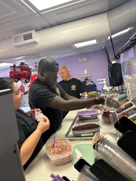 [CREDIT: Warwick Firefighters serve scoops during the Scoops and Sirens fundraiser for the Warwick Animal Shelter Sunday, Aug. 10, 2025.