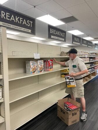 [CREDIT:Jordan Hiatt, Marketplace Supervisor] Lincoln Smith stocks cereal on the shelves at West Bay Marketplace during the Cereal Challenge food drive.