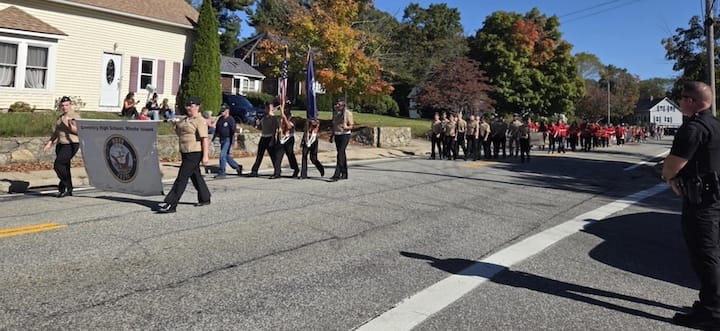 [CREDIT: Mary Carlos] The Coventry High The Navy Junior ROTC cadets march with their Future Oakers banner during the CHS Homecoming parade Oct. 4, 2025
