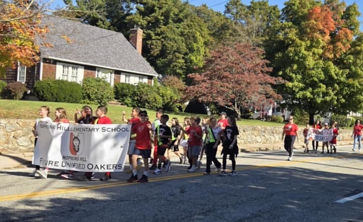 [CREDIT: Mary Carlos] Students of Hopkins Hill Elementary School march with their Future Oakers banner during the CHS Homecoming parade Oct. 4, 2025