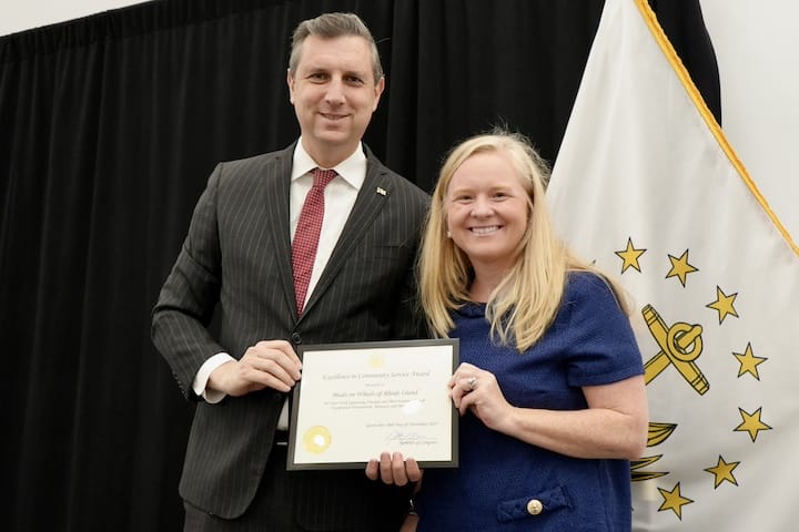 [CREDIT: Katherine Riordan] From Left, Rep. Seth Magaziner and Meghan Grady from Meals on Wheels at the veterans breakfast Monday, Nov. 10, 2025 at Crowne Plaza Warwick.