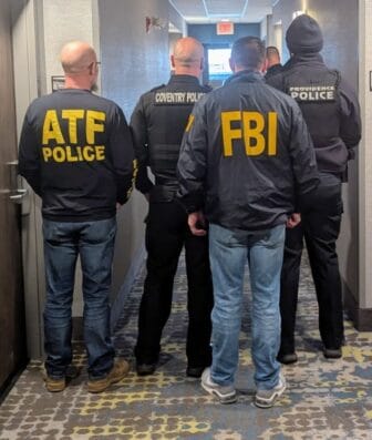 [CREDIT: FBI Boston] A photo of local and federal officers who apprehended a suspect in the Brown University shooting Sunday morning.