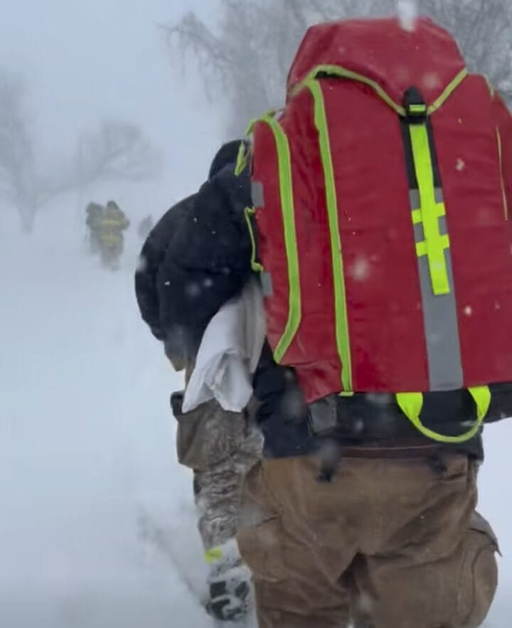 [CREDIT: WFD] Warwick Fire Department responders hike to an emergency call during the blizzard.