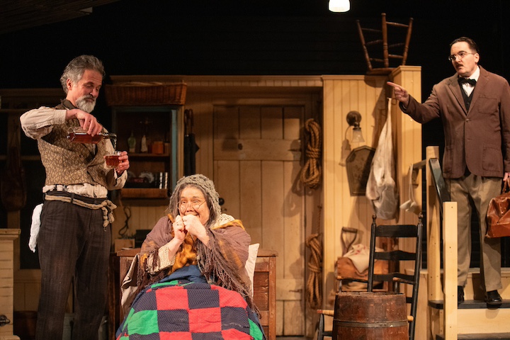 [CREDIT: Cat Laine] From Left, Tony Estrella as JohnnyPateenMike, Casey Seymour Kim as Mammy O'Dougal, Billy's mother, and Brendan O'Malley as Dr. McSharry in  'The Cripple of Inishmaan' at Gamm Theatre, 1245 Jefferson Blvd., Warwick, RI. 